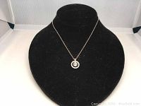 Silver plated Swarovski crystal pendant necklace displayed on black velvet necklace stand.