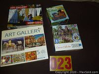 Four puzzle boxes showing the Art Gallery 5 puzzle set, Disney puzzle, and Connoisseur Collection puzzle.