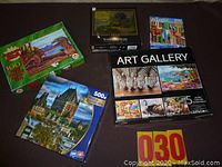 Five puzzle boxes shown with various images and piece counts including a castle, dinosaur, colorful street scene, and zebra images.