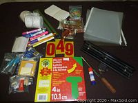 Full view of all stationery items spread on dark surface.