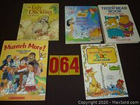 Five hardcover children's books laid out on a surface showing front covers, titles visible including classic and popular children's stories.