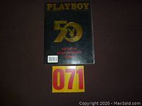 Front cover of the Playboy 50th Anniversary magazine with gold embossed text and black background.