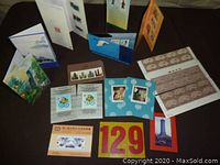 Overview of assorted new Oriental stamps displayed in open booklets and loose sheets.