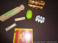 Overview of all hand held musical instruments including pitch pipe, rattle, harmonicas, egg shaker and a small rectangular instrument