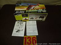 Blade MCX2 radio controlled helicopter box with manual and receipt on table.