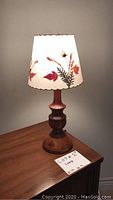 Vintage wooden base lamp with lighted floral botanical pressed leaf fabric shade.