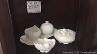 Five white Coalport porcelain pieces arranged together: creamer, sugar bowl, tray, candy dish, and shell candy holder.