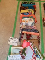 Top view of all scarves neatly folded showing various colors and patterns, with handwritten note 'Lot 158 Assorted Silk Scarves All Colors + Sizes'.