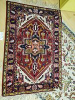 Red geometric area rug with medallion pattern and fringe ends