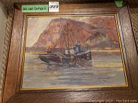 Overall view of framed oil painting depicting fishing vessel and rocky coast