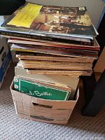 Stack of assorted classical music records in album covers, some with visible titles and composers.