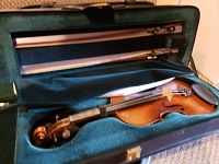 Violin and bow in velvet-lined case with paperwork inside case pocket