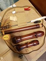 Disassembled Mollenhauer school recorder body and foot joint in canvas case with cleaning brushes