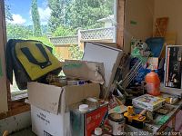 Wide view of lot with boxes, bags and containers of supplies including yellow and black Smart Stripe cutting tool bag and paint cans.