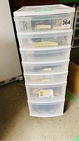 7 drawer plastic roller cart with translucent drawers stacked vertically in a garage or workspace environment.