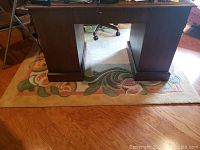 Area rug placed under a large wooden desk, showing overall size and placement.