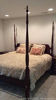 Full view of king size four poster bed frame with mattress and bedding to show overall style and condition