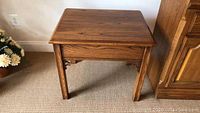 Front angled view of wooden Thomasville side table showing rectangular top and legs