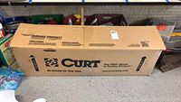 Box for Curt tow bar with brand logo and product info visible, minor box damage noted.