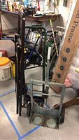 Photo showing two hand trucks and a boxed 45-inch step ladder in background