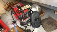 Overview showing MIG welder, helmet and gloves