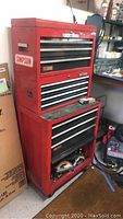 Overview of stacked red Craftsman tool units in garage