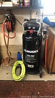 Full frontal view of the Husky air compressor in a garage setting