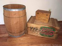 Photo showing the wooden barrel, Genesee wooden ale box with logo, and small wooden box on top