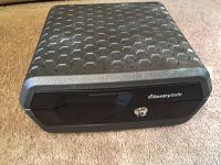 Front view of the small black Sentry Safe showing the key lock and SentrySafe logo.