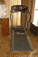 Full view of treadmill showing frame, running belt and console