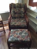 Full view of rattan lounge chair and ottoman showing frame and cushion pattern