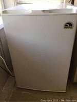 Front view of the white Igloo mini fridge showing overall clean exterior with minor wear.