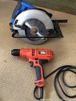 Black & Decker drill and Mastercraft circular saw on carpeted floor