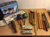 Full lot overview showing keyboard, percussion, maracas, recorders, harmonica and extras