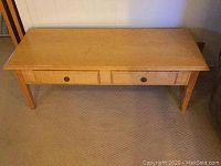 Front view of table showing overall shape and drawer placement