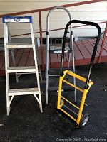 Front view of 3-step Cosco step ladder, folding metal ladder, and yellow reversible trolley side by side