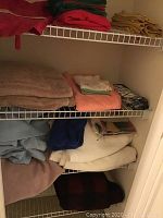 Shelving unit with folded towels and blankets