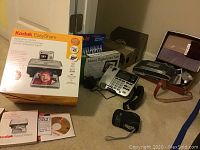 Kodak EasyShare C330 digital photo printer with original box, user guides, and installation CD shown on carpet
