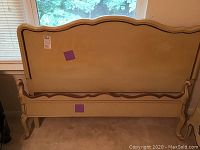 Photo showing full front view of French Provincial style headboard and footboard in light cream color.