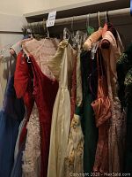 Rack of nine vintage dresses in assorted colors and fabrics