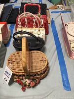 Photo showing six vintage purses arranged in a line on a table, highlighting texture and wear.