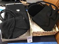 Overall boxed lot showing multiple vintage purses made of black felt, varying shapes including rectangular and rounded forms.