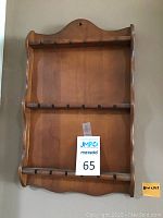 Medium-size wooden rack with two rows of hooks, natural wood finish and curved edges.