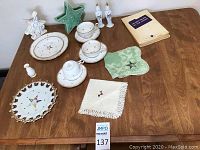 Overview of all items on the table showing Eastern Star porcelain, ceramics, linens, and booklets.