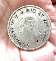 Obverse side of the 1944 Canadian 50 cent silver coin showing King George VI profile with legend around the edge.