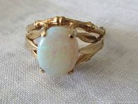 Front view of the ring showing claw-set oval opal and bamboo style band