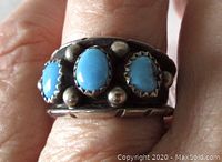 Front view of vintage Navajo sterling silver ring with three oval turquoise stones and silver bead accents.