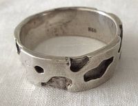 Side view of sterling silver ring showing cutout design and thickness