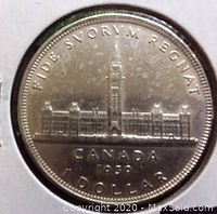 Reverse of 1939 Canadian silver dollar coin showing Parliament buildings and denomination details.