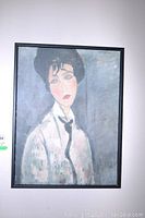 Frontal view of framed portrait painting of a lady showing the entire artwork and frame.